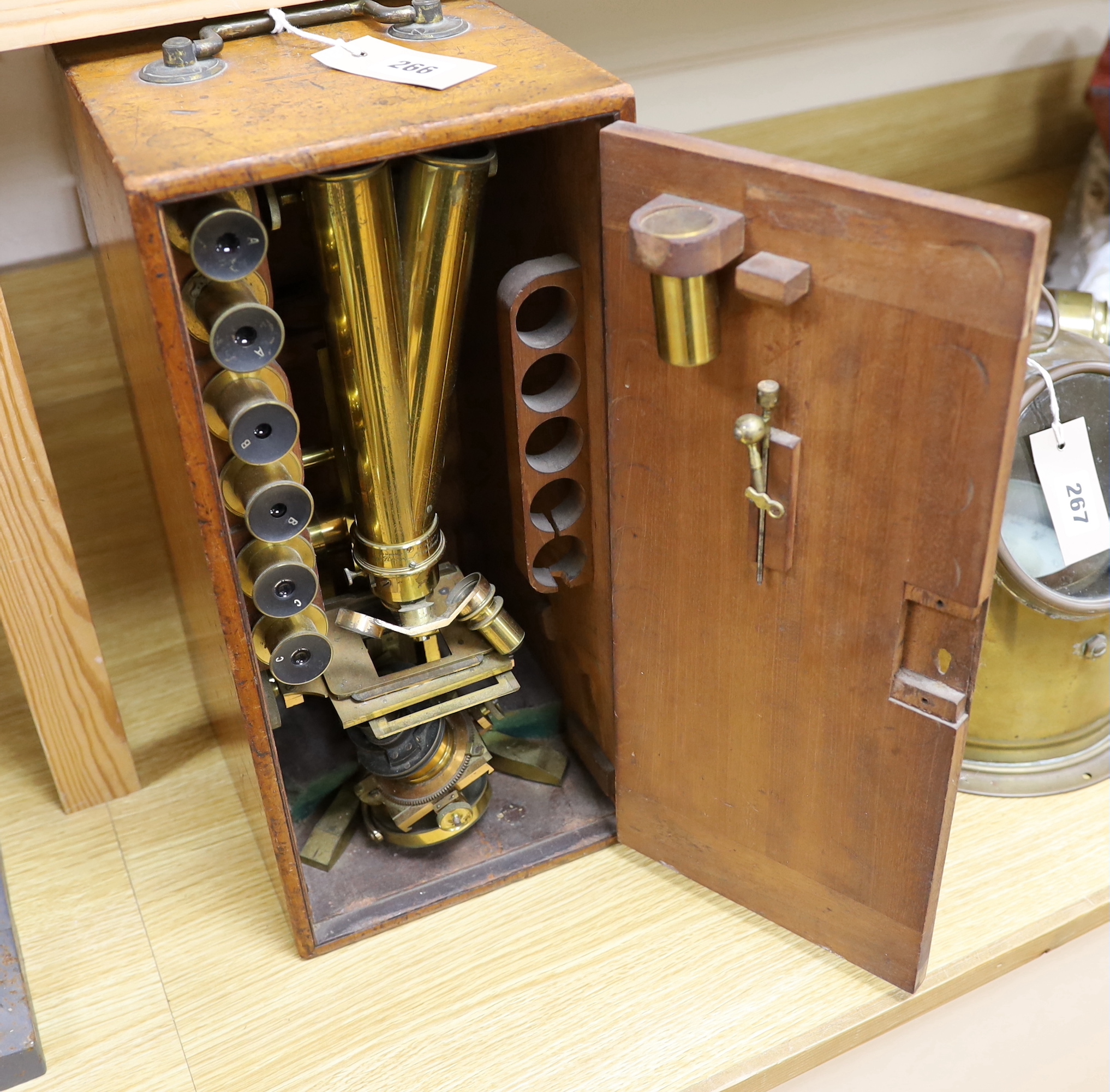 A Ross of London cased 'Wenham's' binocular brass microscope, wooden case with fitted interior and containing three sets of lenses, case 41.5cm high